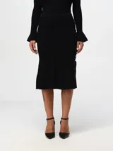 Falda midi negra de tejido de punto acanalado, con silueta ajustada, bajo acampanado y detalle de lazos entrecruzados en el lateral.