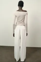 Top de manga larga confeccionado en tejido de algodón, con diseño de escote asimétrico y corte ajustado al cuerpo.