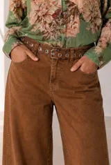 Jeans modelo Rul de corte wide leg en color bordó con efecto gastado, tiro alto y terminación desmechada en el bajo.