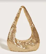 Bolso de mano tipo baguette, color negro, confeccionado en malla metálica con efecto lentejuelas o escamas. Tiene un asa única curva y cierre de cremallera en la parte superior.