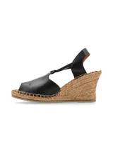 Sandalia de cuña Vilma color negro, con plataforma de yute, capellada de cuero y finas tiras elásticas de ajuste.
