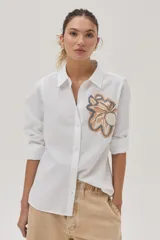Camisa blanca de algodón y lino con bordado de flor en el frente.