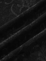 Pantalón de encaje negro con corte acampanado y cintura elástica.