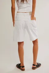 Short de denim blanco de tiro medio, corte bermuda relajada con diseño clásico de cinco bolsillos y cierre frontal.