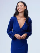 Vestido azul de RM Richards en seda fría, con escote en V cruzado, cintura drapeada, mangas largas de gasa y aplique de botones en el lateral.