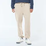 Pantalón de chándal beige liso con cordones ajustables en la cintura.