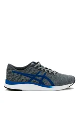 Championes deportivos Asics modelo Streetwise, color azul con diseño melange, suela blanca con detalles en naranja y el logo de la marca en tono rosado en el lateral.