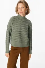 Sweater color crudo con cuello alto y diseño de tejido panal.