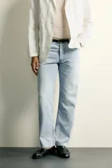Pantalón jeans de corte recto, color celeste claro con efecto lavado, de cinco bolsillos y tiro medio.