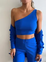 Top corto de tejido texturizado color azul eléctrico, con un solo tirante.