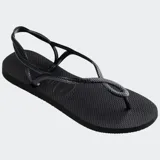 Ojotas Havaianas modelo Luna, color negro, con diseño de tiras trenzadas que se entrelazan en la parte delantera y correa trasera para mayor sujeción.