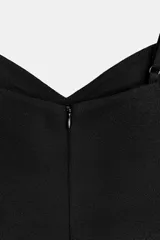 Top de escote en pico con tirantes finos ajustables. Presenta un diseño entallado con costuras verticales decorativas en el frente y bajo recto.