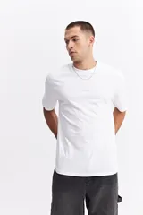 Remera de manga corta color verde militar, con escote redondo y fit regular. Presenta un pequeño estampado de texto en el pecho.