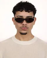 Lentes de sol con armazón de diseño ovalado y estilo envolvente, combinando tonos marrón oscuro y negro. Cuentan con protección UV400.