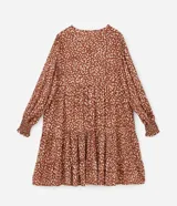 Vestido corto amplio color ladrillo con lunares irregulares color crema, cuello redondo con lazo, mangas largas con puños anchos y bajo fruncido.