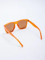 Lentes de sol con armazón de plástico color naranja y lentes marrones con filtro UV400. Incluyen estuche rosado.