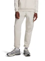 Pantalón deportivo tipo jogger Under Armour de color beige, confeccionado en mezcla de algodón y poliéster, con cintura elástica y puños elastizados en los tobillos.