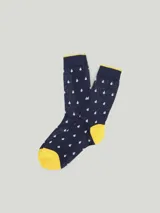 Medias de algodón azul marino con puño amarillo y estampado de gotas blancas.