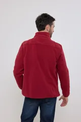 Campera de micropolar color verde oscuro, con cuello alto, cierre frontal completo, bolsillos laterales y un bolsillo con cierre en el pecho.