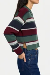 Sweater de punto con diseño a rayas horizontales en tonos verde, bordó, azul marino y gris. Presenta cuello tipo polo con cierre frontal de tres botones, mangas largas y corte cropped.