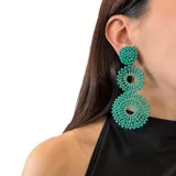 Aros colgantes con forma de círculos tramados con cristales color lila.
