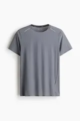 Remera deportiva gris de tejido funcional DryMove™ que ayuda a absorber el sudor. Tiene cuello redondo, costuras laterales adelantadas, aberturas de ventilación en la espalda y detalles reflectantes.