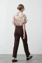 Pantalón ancho de tiro alto, color negro, con pretina y doble botón metalizado.