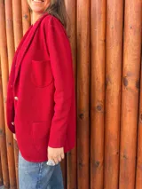 Blazer rojo de algodón, con solapas, dos botones dorados en el frente y puños con botones dorados.
