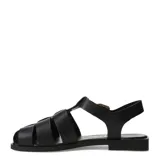 Sandalias franciscanas de cuero negro con tiras cruzadas, suela plana y hebilla metálica dorada lateral.