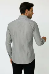 Camisa de algodón de manga larga con diseño de rayas verticales en tonos gris y blanco, cuello camisero clásico y cierre frontal con botones.