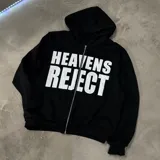 Campera canguro de felpa negra con cierre frontal completo y capucha. Presenta estampado grande en el pecho con el texto "HEAVENS REJECT" en color blanco.