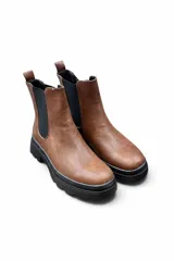 Bota tipo chelsea Splendid color beige, con paneles elásticos laterales negros y suela gruesa track en color negro con plataforma y taco bajo.