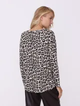 Sweater de algodón color beige con estampado animal print de leopardo en tonos marrón y negro, con escote en V y mangas largas.