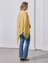 Poncho de tejido calado con acabado brillante, diseño asimétrico y cuello redondo.