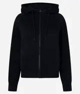 Saco femenino de algodón con capucha ajustable, mangas largas, cierre frontal con cremallera y bolsillos laterales.