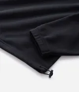 Buzo de corte holgado tipo ballon, color marrón oscuro, con cuello alto y cierre frontal parcial. Presenta mangas largas con puños elásticos y cordón ajustable en el ruedo.