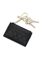Tarjetero de cuero sintético negro con textura granulada y diseño acolchado en rombos, con cuatro ranuras para tarjetas, compartimento superior con cierre y llavero metálico dorado incorporado.