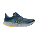 Championes de running New Balance Fresh Foam X 1080v12, color azul con detalles en amarillo y gris.