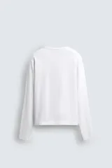 Camiseta de manga larga color gris jaspeado, corte regular fit y cuello redondo con acabado en rib.