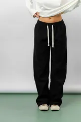 Pantalón de corte relajado y pierna recta, confeccionado en tejido tipo corderoy liviano. Presenta cintura elastizada con cordón ajustable y diseño de silueta amplia.