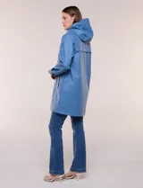 Pilot engomado impermeable color azul, de corte recto estilo trench con acabado resistente al agua. Cuenta con capucha integrada, cierre frontal con broches a presión, bolsillos laterales con ojal y forro interior de tela estampada a cuadros visible en la solapa y los puños.
