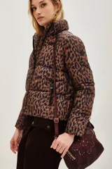 Campera puffer de corte corto con estampado animal print. Cuenta con cierre frontal, cuello alto y bolsillos laterales con cierre.