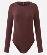 Body de manga larga con cuello redondo, confeccionado en tejido de poliamida y elastano sin costuras. Presenta un diseño ajustado al cuerpo con cierre inferior mediante botones de presión.