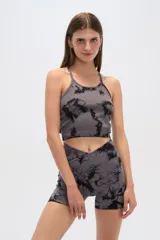 Top deportivo de breteles finos, al cuerpo y con cuello redondo, con diseño tie-dye en tonos marrón y negro.
