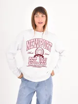 Buzo de cuello redondo en color gris melange, con estampa estilo universitario en tonos bordó y rosa en el frente.