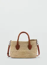 Bolso tipo canasta de tamaño pequeño, confeccionado en hoja de palma de coco trenzada. Presenta doble asa corta trenzada y correa larga desmontable, ambas en cuero color marrón. Incluye detalles de cuero en la unión de las asas y herrajes metálicos.