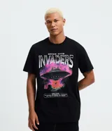Remera negra de algodón con cuello redondo, manga corta y estampado gráfico frontal con temática espacial y de gatos ("Space Cats Invaders").