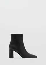 Botín de cuero vacuno color negro, con diseño de punta cuadrada y tacón bloque de 7 cm. Cuenta con cierre lateral de cremallera para un ajuste cómodo.