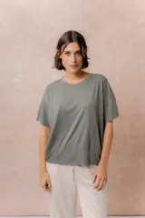 Remera negra de corte oversize con cuello redondo, mangas cortas amplias, hombros caídos y recortes delanteros.