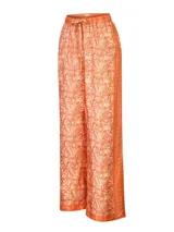 Pantalón holgado de corte ancho, color naranja con estampado botánico y franjas laterales texturizadas. Cuenta con cintura elástica ajustable mediante cordón.